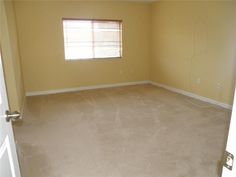 an empty room with yellow walls and no furniture in the house or office area is shown