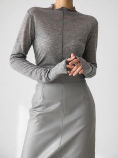 Long sleeve t-shirt with half turtleneck and stitching details. Sheer fabric look in tencel wool blend. Model is in MINUSEY ONE SIZE. ✔️ Free worldwide express shipping over $100✔️ Loved by 6,500+ customers✔️ Limited edition collections, maximum style⠀⠀⠀⠀⠀⠀⠀⠀⠀Stay ahead of the trend with can’t-find-anywhere-else staples. Your closet will thank you 💕 * MINUSEY ONE SIZE = EU 34-38, US 2-6* 70% Tencel / 30% Wool* Dry clean* Made in Korea - Model Height: 170cm/5'7" (US2, EU34) Gray Funnel Neck Top For Layering, Gray High Neck Tops For Layering, Fitted Turtleneck T-shirt, Stretch Mock Neck Top For Layering, Gray Fine Knit Top For Layering, Stretch T-shirt For Workwear In Fall, Gray Turtleneck Top For Layering, Gray Winter Tops With Thumbholes, Stretch T-shirt For Winter Layering