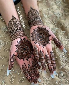 two hands with henna designs on them