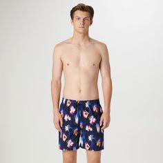 The Cosmo swim trunks are crafted from premium comfort stretch polyester in a floral print and feature an elastic waist with adjustable drawstring, a breathable stretch mesh lining, drainage grommets, side pockets, a rear patch flap pocket, UV protection and quick-dry technology. The sleek 17.5-inch out seam, offers the perfect balance between coverage and freedom of movement, making it an ideal choice for the beach or relaxing by the pool. Spring Swim Trunks With Pockets, Blue Swim Trunks For Spring Beachwear, Blue Beachwear Swim Trunks For Spring, Printed Blue Shorts For Swimming, Blue Printed Swim Trunks, Blue Floral Print Beachwear Shorts, Spring Printed Blue Swim Trunks, Spring Blue Printed Swim Trunks, Navy Swim Trunks For Pool