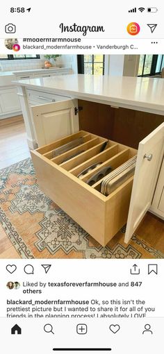 an open drawer in the middle of a kitchen