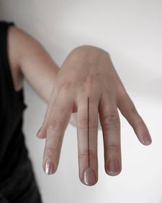 a woman's hand with two fingers on it