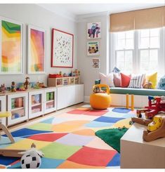 a child's playroom with colorful rugs, toys and artwork on the walls