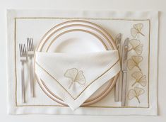 a place setting with napkins and silverware