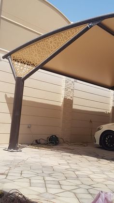 a car is parked under an awning outside