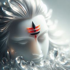 a white mask with an orange and black feather on it's forehead is surrounded by water droplets