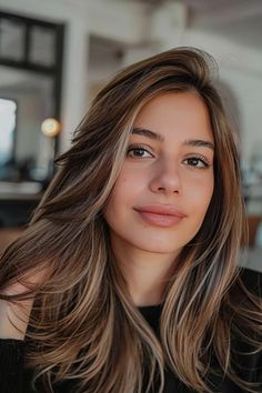 Young woman with medium-length brown hair and subtle makeup smiling softly at the camera. Old Money Brunette Hair, Old Money Hair Color, Rich Balayage, Old Money Brunette, Brunette Hair Color Ideas, Chocolate Brunette, Brunette With Blonde Highlights, Brunette Hair Cuts, Subtle Blonde Highlights