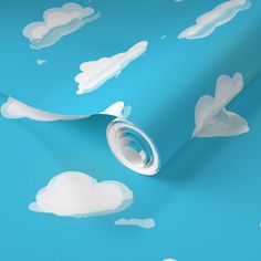 a blue wallpaper with white clouds on it and a roll of paper in the foreground