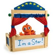 an orange stuffed animal in a wooden bed with red drapes and stars on it