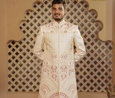 This is a Premium Sherwani by Golden Attire crafted from high quality fabric and imported materials. Our products are handcrafted by experienced tailors who make sure the that the stitching is precise, lining is proper and the overall product is sturdy enough to not go out of shape for more than a few years. Also all our products have extra margins in their length, sleeves, sides so it's easily alterable if your size changes after some time. To see more available colours and designs in this collection, Check out the 'Classic  Sherwani' Section. *After you place your order we will send some information on your WhatsApp number for your better fitting. *Feel Free to message us if you have any question or doubts, even if you just want to say hi. We love making new friends! *Free Delivery in 3- White Naqshi Lehenga For Eid, Festive White Lehenga With Naqshi Detailing, Traditional White Lehenga With Naqshi, White Naqshi Lehenga For Wedding, Off White Naqshi Traditional Wear For Wedding, Off White Long Sleeve Sherwani With Pallu, Royal Sherwani, Ivory Sherwani, Sherwani For Groom