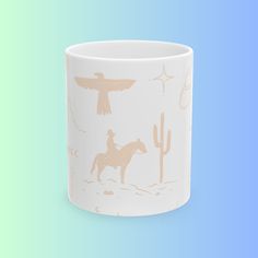 a white coffee mug with an image of a man on a horse in the desert