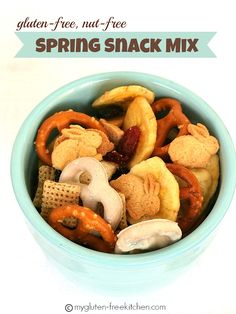 a blue bowl filled with fruit and crackers next to the words gluen free, nut - free spring snack mix