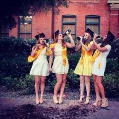 four girls in yellow dresses are standing together