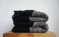 three black and white towels stacked on top of each other