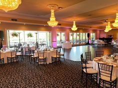 a banquet room set up with tables and chairs