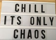 the words chill it's only chaos written in black on a white lightbox