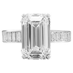 This exquisite ring showcases a breathtaking 4.05 carat emerald cut diamond, GIA-certified for its superior quality. Set in luxurious 18K white gold, the centerpiece diamond boasts an H color grade and VS1 clarity, ensuring a near-flawless appearance with a captivating balance of brilliance and subtle warmth. With excellent ratings for both polish and symmetry, the diamond exhibits remarkable light performance and precision, creating an eye-catching sparkle. The elegant band is adorned with 22 meticulously set baguette-cut diamonds, 11 on each side, perfectly complementing the central stone and adding extra refinement to the overall design. The absence of fluorescence allows the diamond’s natural radiance to shine without interference, making this ring a true symbol of timeless elegance an Estate Diamond Jewelry, Rare Diamond, Brilliant Cut Diamond Ring, Emerald Cut Diamond Ring, Platinum Diamond Rings, Modern Engagement Rings, Emerald Cut Diamond, Antique Engagement Rings, Platinum Ring