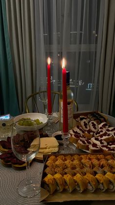 a table topped with lots of food and candles