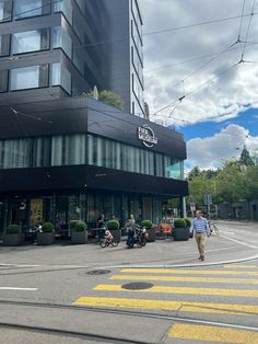 people are walking on the street in front of a building