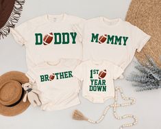 two matching shirts that say daddy and daughter, both with footballs on the back