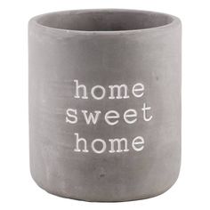 a gray vase with the words home sweet home written in white on it's side