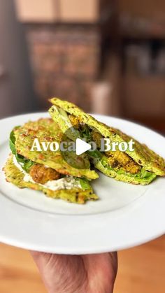 a person holding a white plate with food on it and the words avocado broth