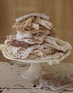 a white cake plate topped with lots of doily