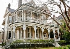 an old victorian style house with white trim