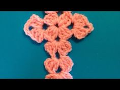 a crocheted cross on a blue background