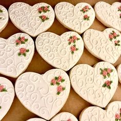 white heart shaped cookies with pink flowers on them