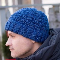 a man wearing a blue knitted hat