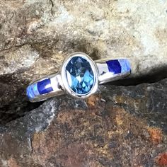 This beautiful Sterling Silver Ring, as part of the Blue Sky Collection, features Royal Lapis, Denim Lapis and Cultured Opal. Dimensions: 3/8"W at top; Shank is 1/8"W The ring is designed by David Rosales, one of the finest contemporary Southwest Artists in the world. He is the founder and co-owner of Supersmiths, Inc. of Gallup, NM. Each ring is custom made and carries a lifetime guarantee. Contemporary Southwest, Arrow Jewelry, Sky Collection, Black Arrow, The Blue Sky, Southwest Jewelry, Blue Topaz, Sterling Silver Ring, Jewelry Art