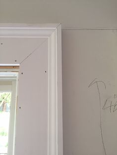 a room that has been painted white with some writing on the wall next to it