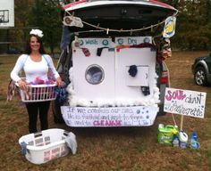 a woman standing in front of a washing machine with laundry baskets on the back of it