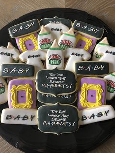 baby shower cookies are arranged on a plate