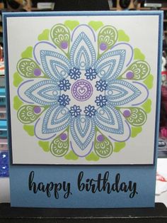 a happy birthday card with an intricate flower design on the front, and blue background