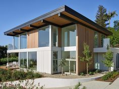 a modern house with lots of windows on the outside