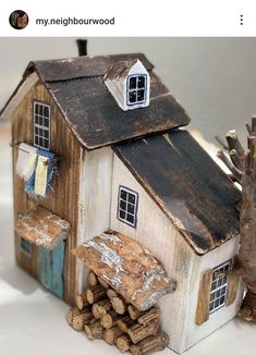 a small house made out of wood and logs