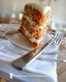 a piece of carrot cake sitting on top of a glass plate