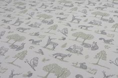 an animal print fabric with trees, animals and houses on it's white background