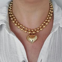 "This eye-catching statement necklace has a large puffy heart pendant on a thick gold filled ball chain. The whole piece is made of 18K gold filled brass, which looks almost like 18K solid gold. You can mix and match this necklace with your other gold or gold plated necklaces for a chic look.  This necklace can be sold separately or as a set with another 6 mm plain ball chain. The two chains complement each other and create a layered effect. The set is also available for purchase. MATERIALS: - 1 Chunky Heart-shaped Gold Jewelry, Chunky Heart-shaped Gold Necklace, Chunky Heart Shaped Gold Jewelry, Gold Chunky Heart-shaped Jewelry, Chunky Heart Pendant Necklace For Valentine's Day, Gold-tone Chunky Necklace As Gift, Chunky Gold-tone Necklace For Gift, Gold Heart Beads Choker Necklace, Gold Chunky Heart Necklace