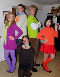 a group of people in costumes posing for a photo