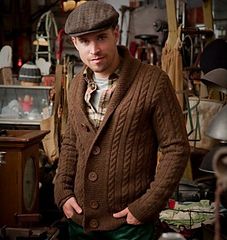 a man wearing a hat and sweater in a shop