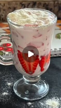 a dessert in a glass with strawberries on top