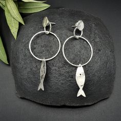 "This beautiful pair of earrings is composed by little silver fishes and rings. Thanks to its lightness, the various pieces have a great capacity of movement. Very easy to wear,capable of giving you a natural and rustic touch. I hammered them piece by piece, to give you all the most unique result! This piece is entirely made by myself, soldering sterling silver (925) with traditional Jewelry techniques. Every piece is unique! Dimensions: Lenght: 3.18\" 81mm Width: 1.29\" 33mm The earrings will b Handmade Fish-shaped Earrings For Gifts, Silver Fish-shaped Earrings With Ear Wire, Handmade Silver Fish-shaped Earrings, Handmade Sterling Silver Fish-shaped Jewelry, Handmade Sterling Silver Fish Jewelry, Nickel-free Silver Fish-shaped Earrings, Silver Sterling Fish-shaped Earrings, Silver Fish-shaped Sterling Silver Earrings, Fish Earrings