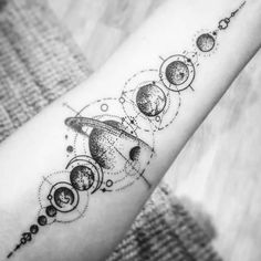 a woman's arm with an image of the solar system and planets on it