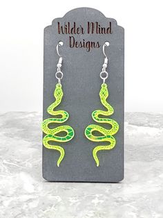 Snake Earrings! They are made from Lime Green Mirror Acrylic- they are lime green mirror on the front with a matte back. These earrings are laser cut, laser engraved and are super lightweight making them easy to wear all day!  *Please Reference Size Guide Picture for sizing* Ear wires are made from surgical stainless steel. Since these earrings are handmade, I highly recommend taking them off for any water related activities such as swimming or showering and while sleeping. They come packed on a Green Hypoallergenic Novelty Earrings, Green Novelty Dangle Earrings, Green Dangle Novelty Jewelry, Green Novelty Dangle Jewelry, Handmade Green Novelty Earrings, Green Handmade Novelty Earrings, Earrings Snake, Snake Lovers, Green Mirror