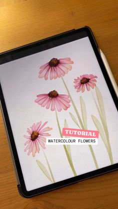 a wooden table topped with a black tray covered in pink and white flowers next to a pen