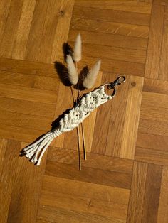 a pair of scissors and some feathers on a wooden floor