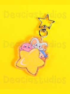 a star shaped keychain with cartoon characters on it